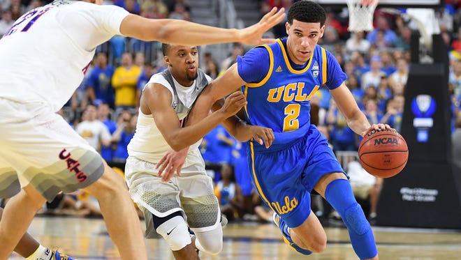 UCLA Bruins guard Lonzo Ball (2) dribbles past the defense of Arizona Wildcats guard Parker Jackson-Cartwright (0) during the Pac-12 Conference Tournament at T-Mobile Arena.