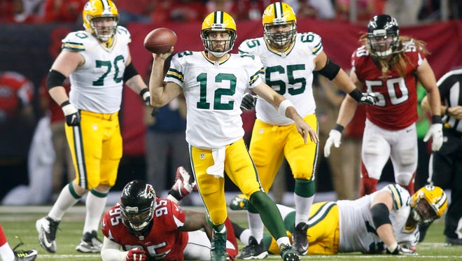 Green Bay Packers quarterback Aaron Rodgers (12) scrambles against the Atlanta Falcons in the fourth quarter at the Georgia Dome.
