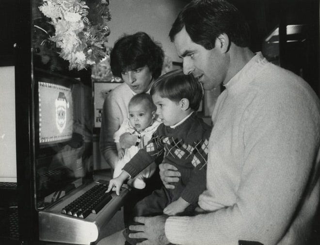 Visitors in 1984 check out one of the Santa E-Mail computers that children used to write Santa. COSI connected Commodore 64 terminals with CompuServe to create the North Pole Computer Connection.