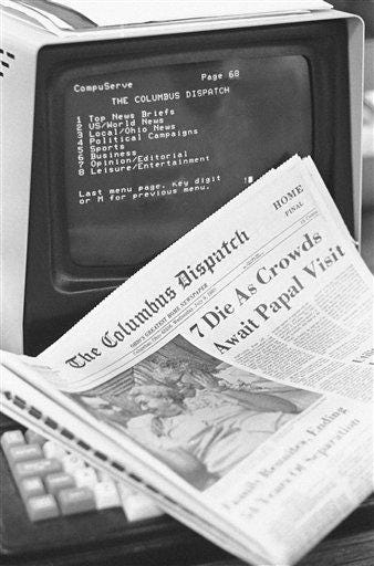 A copy of the Columbus Dispatch and a computer terminal listing the index for Dispatch and Associated Press stories which can be viewed through the CompuServe system in Columbus, Ohio on July 9, 1980. (AP Photo)