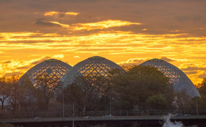 The sun rises behind the Mitchell Park Domes Horticulture Conservatory in Milwaukee in November, 2021.