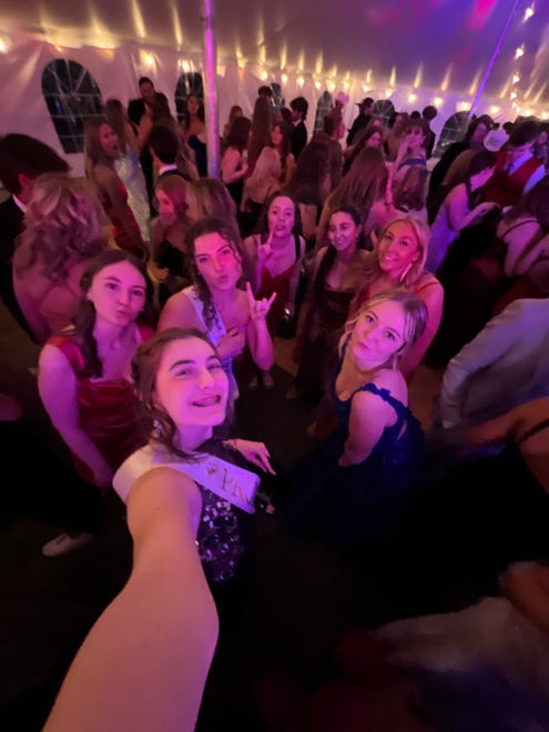Hortonville prom queen Sarah Bendorf takes a selfie with her squad on the dance floor during the prom on Saturday, April 13, 2024, at the Homestead Meadows Farm in Appleton.