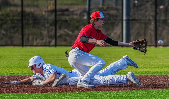 Oak Creek's Nate Schopf (35) steals second as Racine Horlick's Connor Blaeske (3) waits on the throw during the game at Oak Creek, Friday, April 19, 2024.