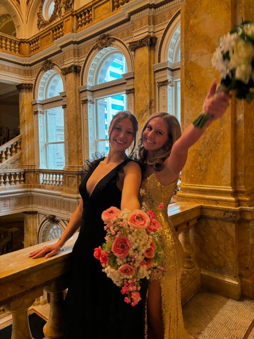 Sussex Hamilton junior Liv Frea (right) is all smiles for a prom photo on Saturday, April 20, 2024, at the Milwaukee Public Library before heading to the dance at the Chandelier Ballroom in Hartford.