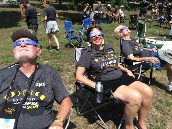 Larry Fox and his wife Meg of Shorewood (from left) and his sister-in-law Julie Attermeier of Greenfield watch the total solar eclipse on August 21, 2017, from Fort Massac State Park in Metropolis, Ill. They were part of a group of 110 people from the Milwaukee Public Museum that traveled to southern Illinois to see the eclipse.