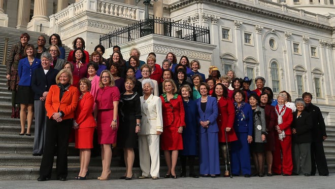 House Minority Leader Nancy Pelosi, D-Calif., in in blue pant suit in the center of the bottom row, poses with other Democratic women in the 113th Congress.