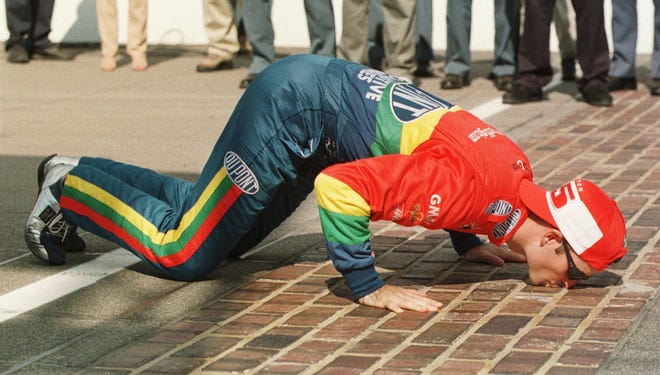 Gordon kisses bricks at Indianapolis Motor Speedway after winning the Brickyard 400 for the second time on Aug. 1, 1998.