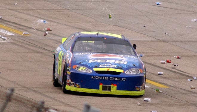 Fans toss beverage containers at Gordon after he beat Dale Earnhardt Jr. in the Aaron's 499 at Talladega Superspeedway under caution on April 25, 2004.