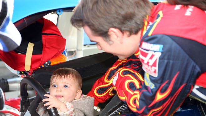 Gordon plays with daughter Ella Sofia, born June 20, 2007, before the Auto Club 500 at Fontana, Calif., on Feb. 24, 2008.