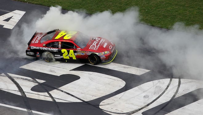 Gordon celebrates with a burnout after winning the Sprint Cup race at Atlanta Motor Speedway on Sept. 6, 2011. Gordon won three races and finished 11th in the standings.