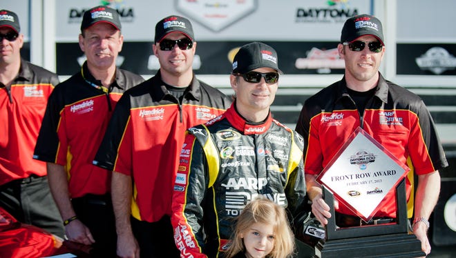 Gordon, second from right, poses with daughter Ella Sofia, crew chief Alan Gustafson and the rest of his crew after finishing second in qualifying for the 2013 Daytona 500 on Feb 17.